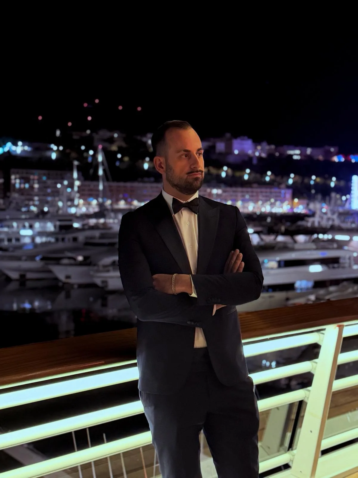Andrea Battista, Head of Legal at CGPH Banque d’Affaires, pictured at the Monaco Yacht Club during the Christmas Gala of the Monte-Carlo Ambassador Club, overlooking Port Hercules at night